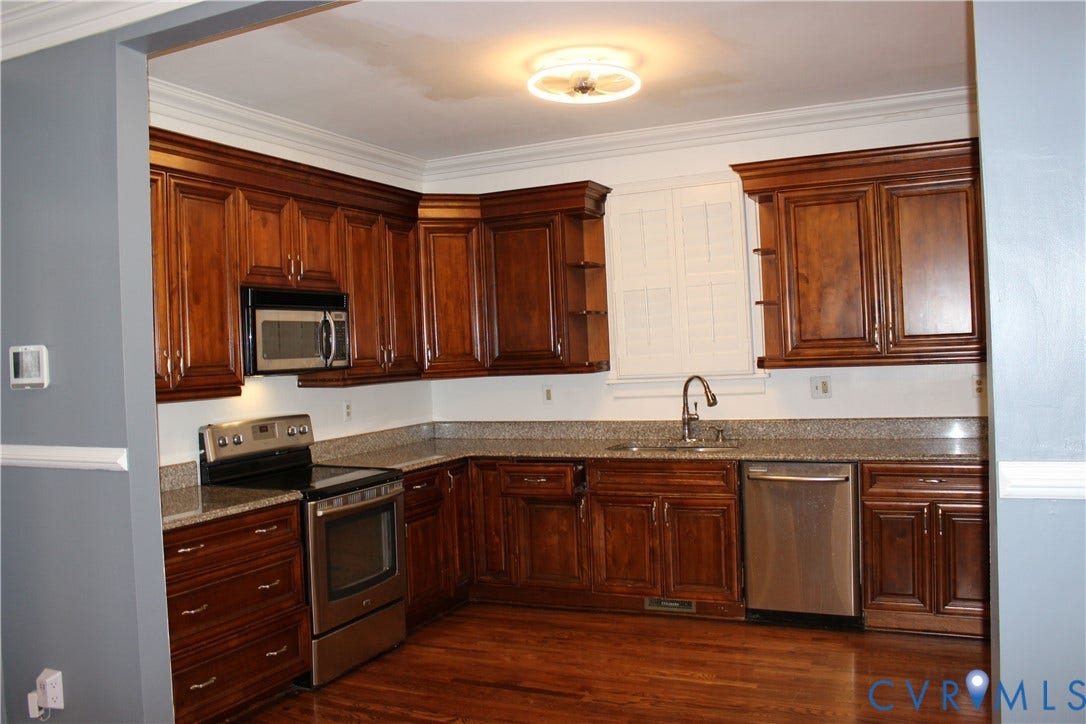 3013 Hawthorne, Richmond, VA 23222 Kitchen featuring wood-finish cabinetry, granite-style countertops, stainless steel appliances, a stainless steel sink with a gooseneck faucet, and wood-finish flooring
