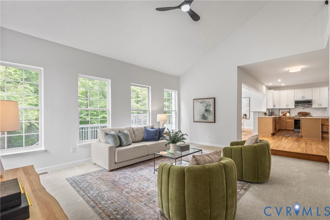 3929 Meadowview Lane, Richmond, VA 23223 Bright, open living area featuring multiple large windows with natural light, neutral wall finishes, and hardwood flooring