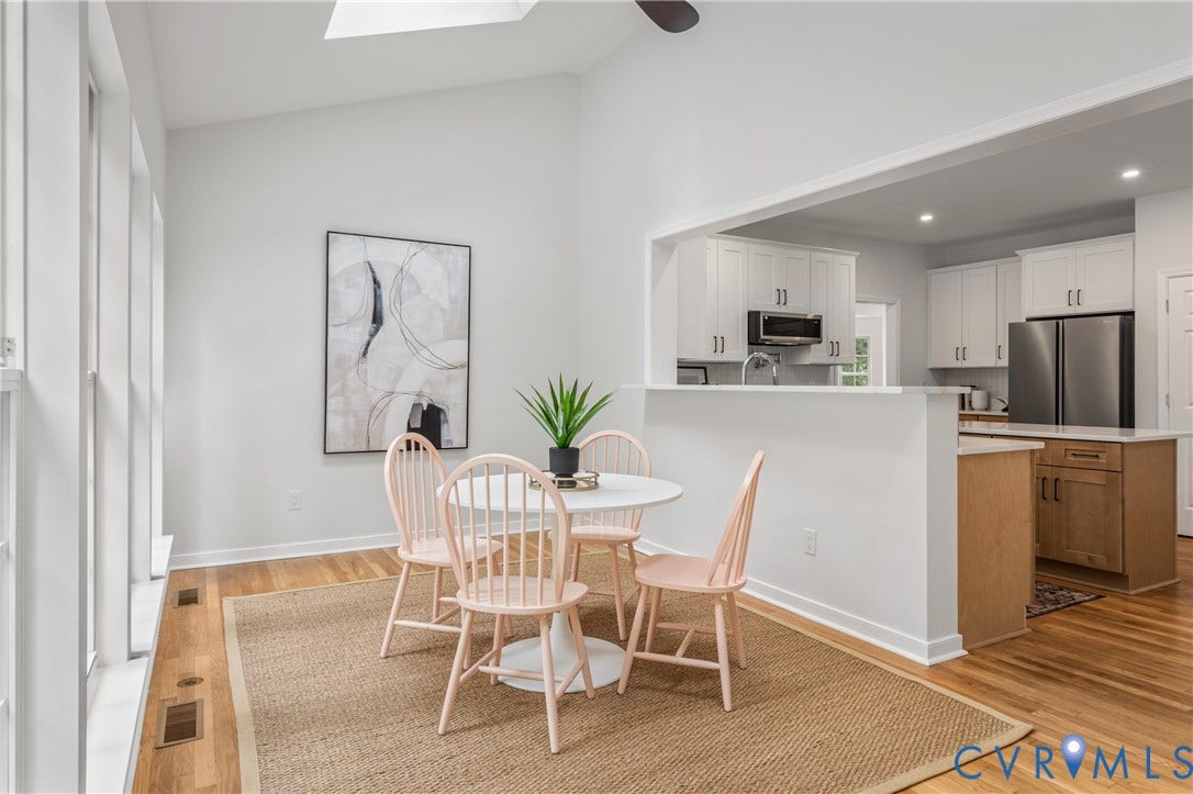 3929 Meadowview Lane, Richmond, VA 23223 Open dining area with round pedestal table, Windsor-style chairs, and natural light from skylights
