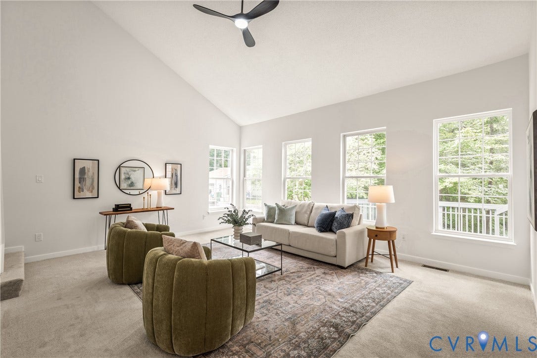 3929 Meadowview Lane, Richmond, VA 23223 Vaulted ceiling, multiple large windows, ceiling fan, and light-toned carpeting