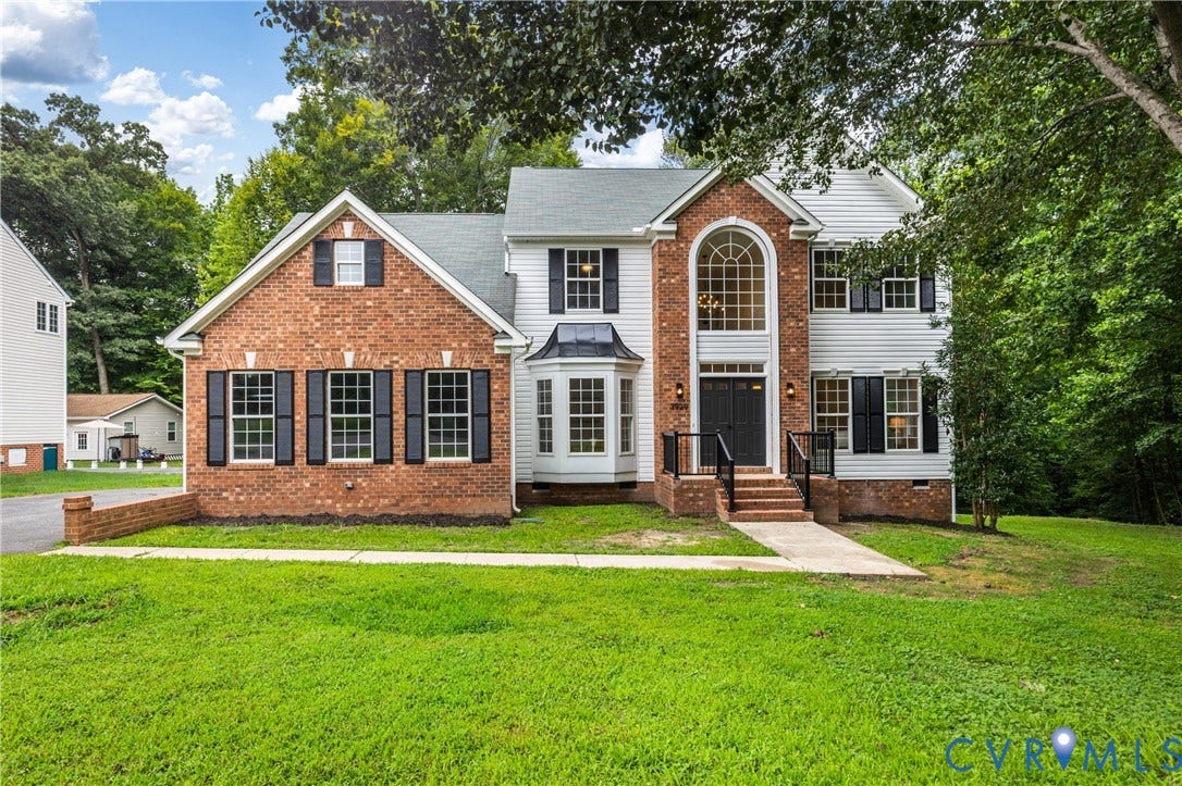 3929 Meadowview Lane, Richmond, VA 23223 Brick Colonial featuring a two-story design with a prominent gabled entry, arched window detail, and multi-pane double-hung windows