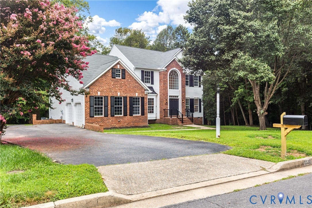 3929 Meadowview Lane, Richmond, VA 23223 Brick Colonial residence featuring a two-car attached garage, columned front entry, and multi-pane windows