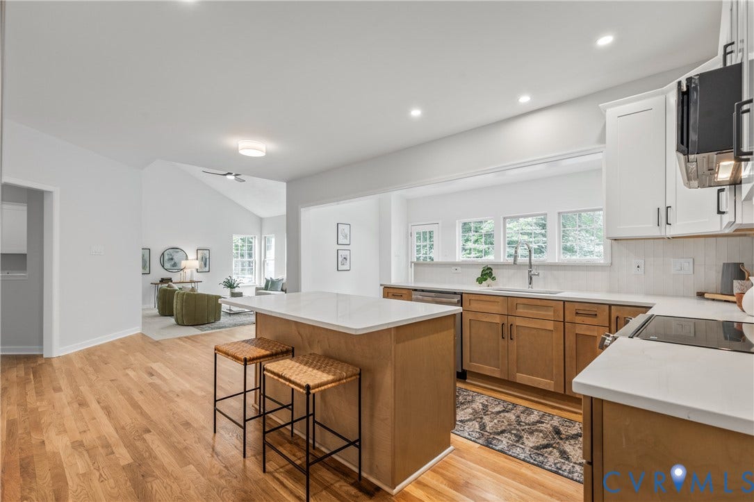 3929 Meadowview Lane, Richmond, VA 23223 Kitchen featuring wood-finish flooring, an island with a light-toned countertop, recessed lighting, and a window over the sink