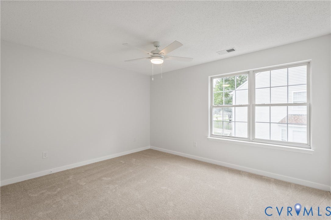 3929 Meadowview Lane, Richmond, VA 23223 Neutral wall paint, light-colored carpeting, white window trim, and a ceiling fan with integrated lighting