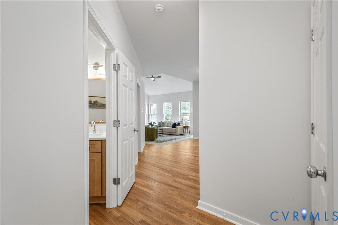 3929 Meadowview Lane, Richmond, VA 23223 Bright hallway with white painted walls and wood-finish flooring throughout