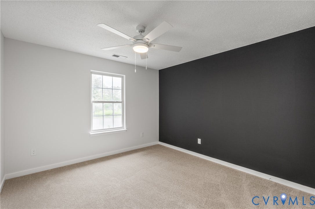 3929 Meadowview Lane, Richmond, VA 23223 Bright bedroom featuring neutral carpet flooring, ceiling fan with integrated lighting, and a large double-hung window with natural light