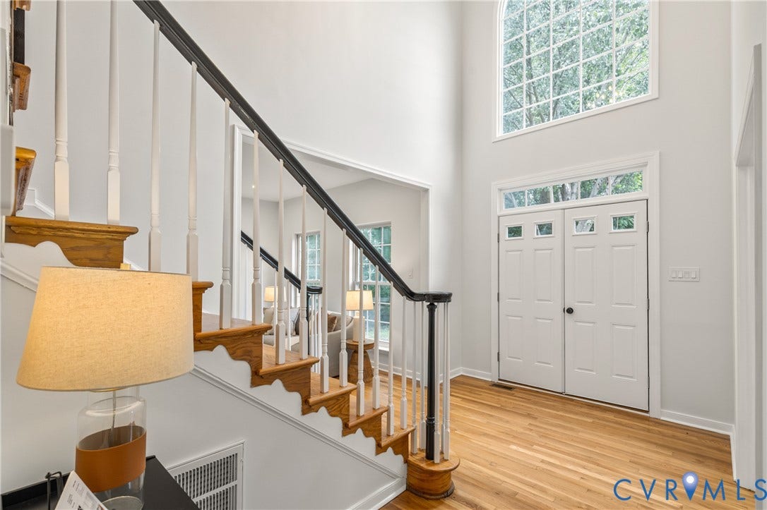 3929 Meadowview Lane, Richmond, VA 23223 Hardwood flooring, painted double entry doors with transom windows, and a grand staircase with wood treads and painted balusters