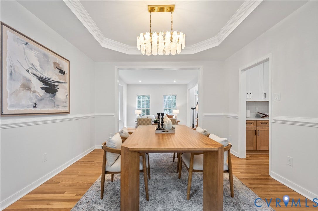 3929 Meadowview Lane, Richmond, VA 23223 Elegant dining room featuring a wood table, hardwood flooring throughout, and a coffered ceiling with brass-accented pendant lighting