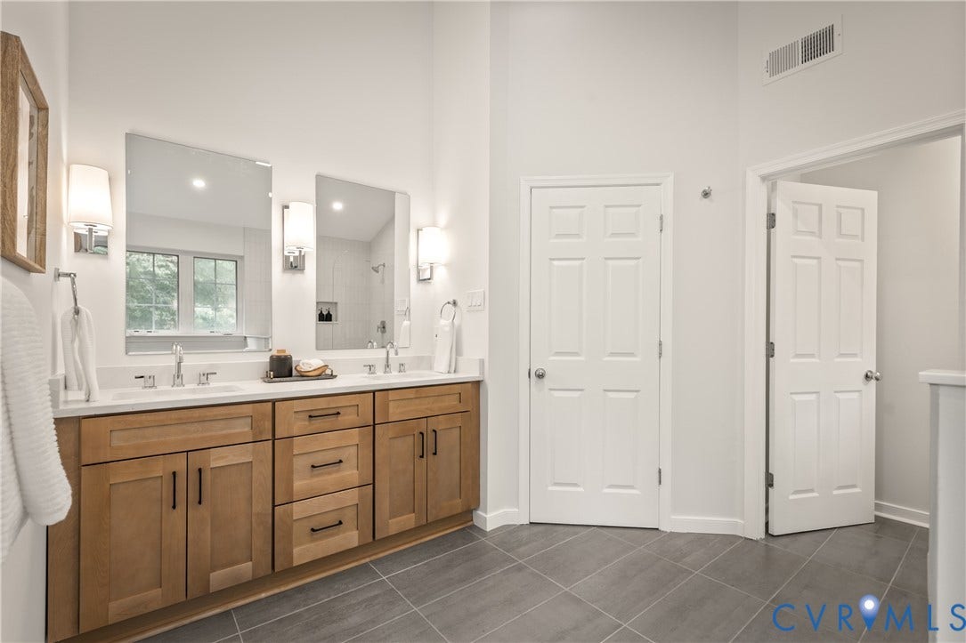 3929 Meadowview Lane, Richmond, VA 23223 Dual vanity with a white countertop and natural wood-finish cabinetry