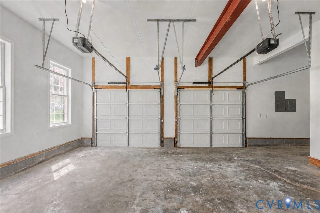 3929 Meadowview Lane, Richmond, VA 23223 Two overhead garage doors with automatic openers, exposed structural beam, and two double-hung windows