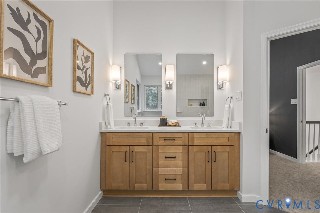 3929 Meadowview Lane, Richmond, VA 23223 Dual vanity with a light wood finish, white countertop, and integrated sinks
