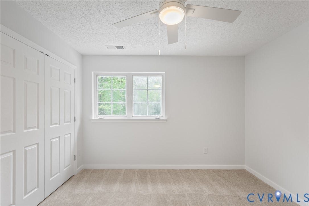 3929 Meadowview Lane, Richmond, VA 23223 Soft carpet flooring, paneled bifold closet doors, a double-hung window, and a ceiling fan with integrated lighting