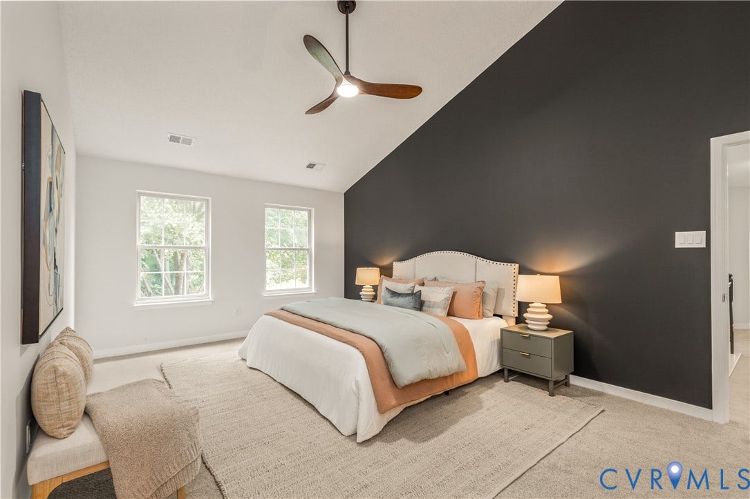 3929 Meadowview Lane, Richmond, VA 23223 Vaulted ceiling, two windows, ceiling fan, carpeting, and a dark accent wall