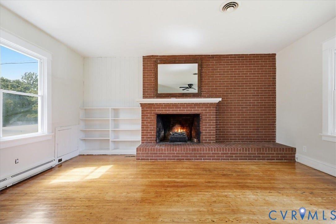 7232 Hopkins Road, North Chesterfield, VA 23237 Brick fireplace with a white mantel, wood-finish flooring, and built-in shelving