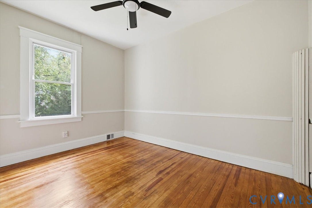 7232 Hopkins Road, North Chesterfield, VA 23237 Wood-finish flooring, white trim, and a ceiling fan