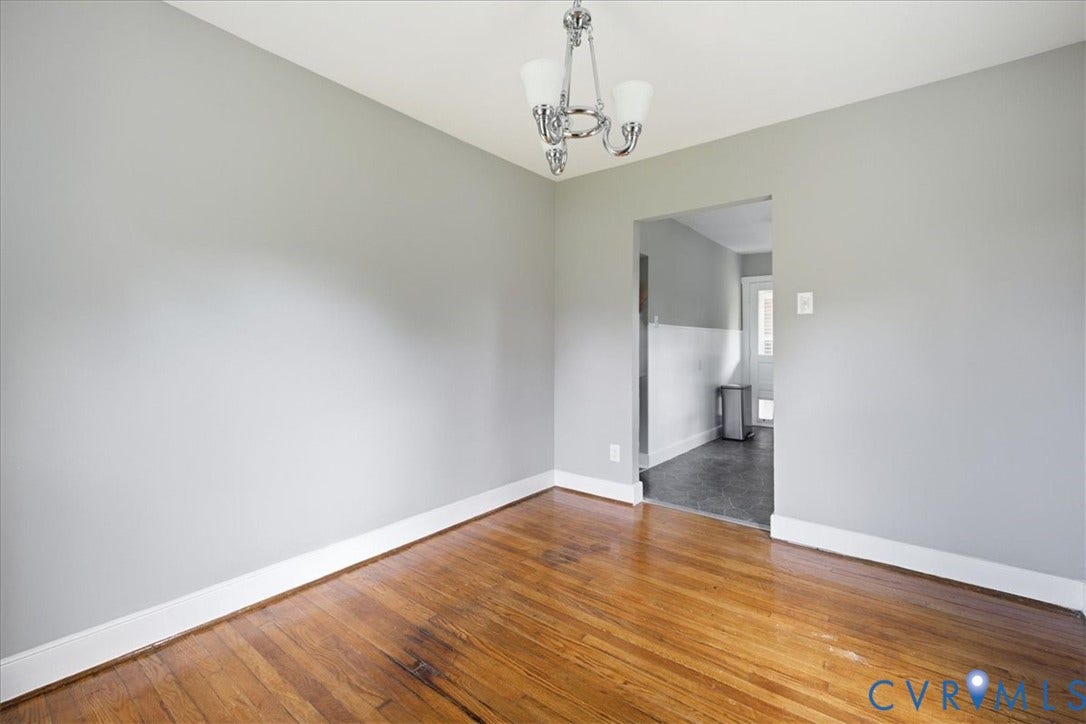 7232 Hopkins Road, North Chesterfield, VA 23237 Wood-finish flooring with white trim, light gray walls, and a ceiling-mounted chandelier