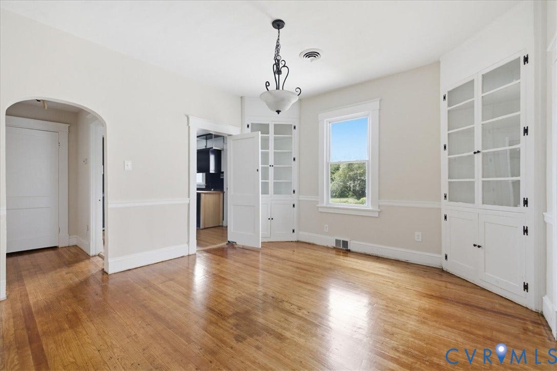 7232 Hopkins Road, North Chesterfield, VA 23237 Hardwood flooring, painted walls with chair rail trim, built-in display cabinetry, and a central light fixture