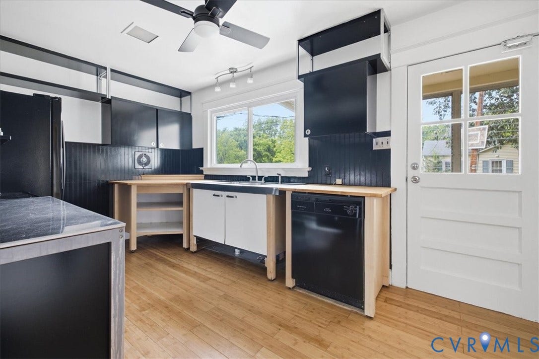 7232 Hopkins Road, North Chesterfield, VA 23237 Contemporary kitchen featuring custom wood-finish cabinetry with integrated black appliances, stainless steel sink with professional faucet, and wood-finish flooring throughout