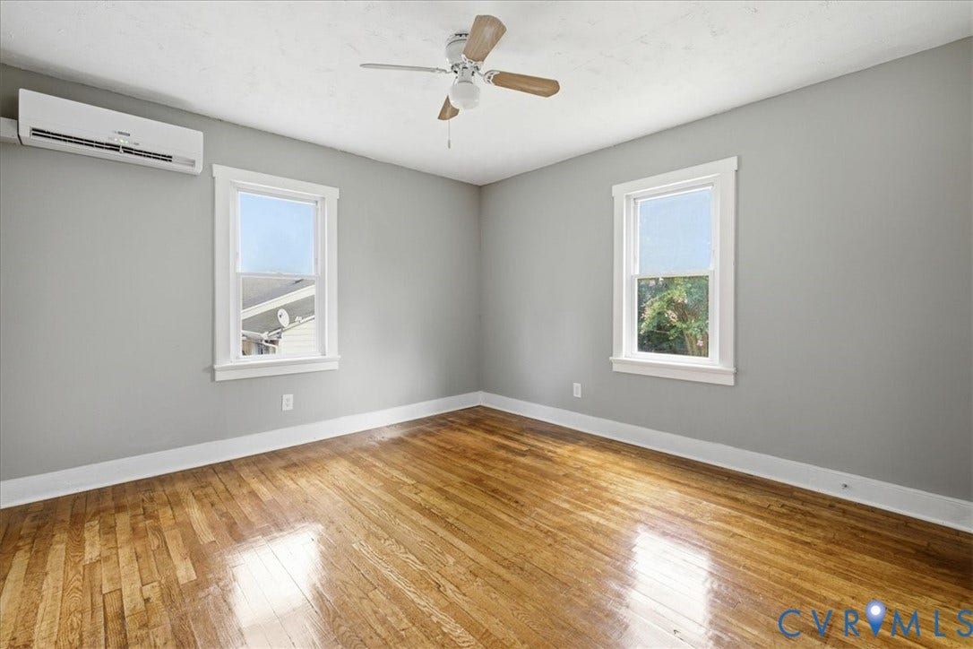 7232 Hopkins Road, North Chesterfield, VA 23237 Hardwood flooring, painted walls, ceiling fan, white trim, and a split-system air conditioning unit