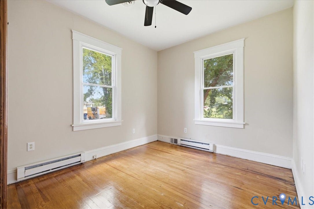 7232 Hopkins Road, North Chesterfield, VA 23237 Hardwood flooring, painted walls, two windows with white trim, and a ceiling fan