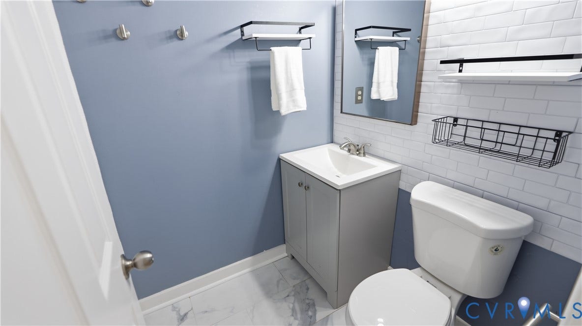 Vanity with an integrated sink, polished chrome faucet, and storage cabinet