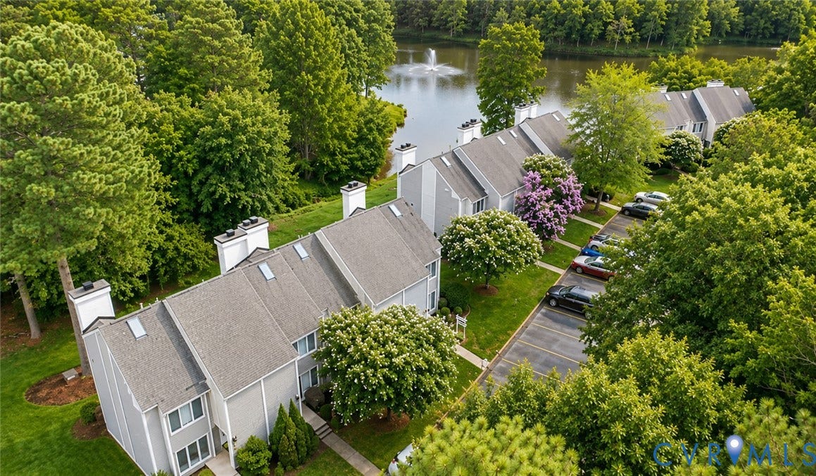 Townhouse community featuring pitched roofs and multiple chimneys