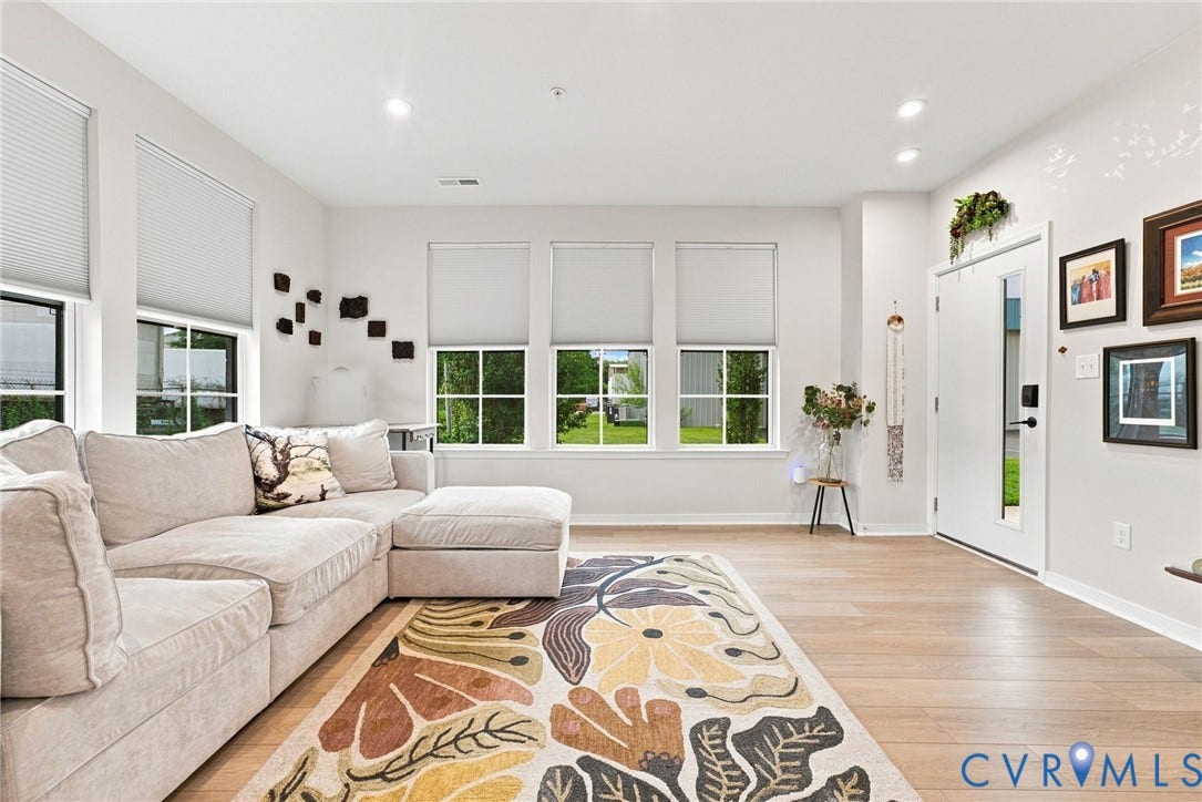 2445 Ownby Lane, #B15, Greater Scott's Addition, Richmond, VA 23220 Recessed lighting illuminates wood-finish flooring and multiple windows, enhancing the bright white walls and ceiling