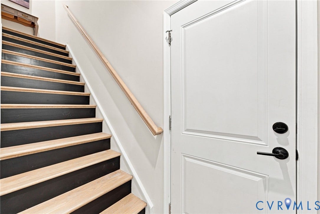 2445 Ownby Lane, #B15, Greater Scott's Addition, Richmond, VA 23220 Staircase with light wood treads and dark risers, accompanied by a natural wood handrail