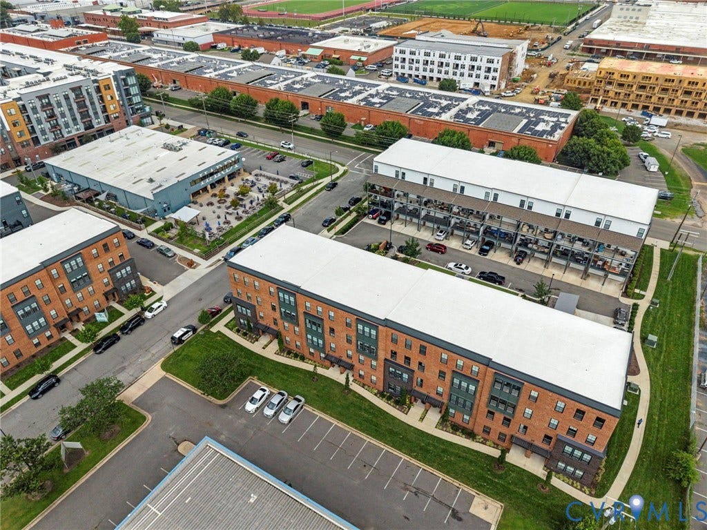 2445 Ownby Lane, #B15, Greater Scott's Addition, Richmond, VA 23220 Brick-clad multi-story buildings with residential units, surrounding areas with paved roads, and dedicated parking areas