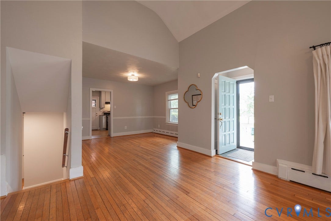 5709 Monument Avenue, Richmond, VA 23226 Living Room with hardwood floors flows into the Dining Room and access to the lower level.