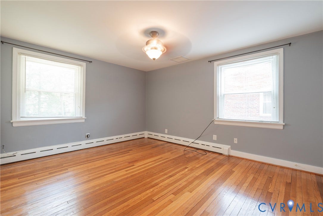 5709 Monument Avenue, Richmond, VA 23226 Primary Bedroom with Hardwood flooring, natural light from two windows, a ceiling-mounted light fixture