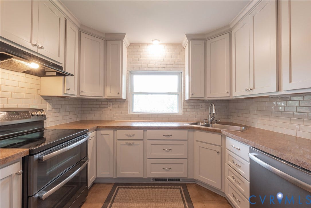 5709 Monument Avenue, Richmond, VA 23226 Kitchen cabinetry with crown molding, subway tile backsplash, stainless steel sink, built-in electric range, and dishwasher
