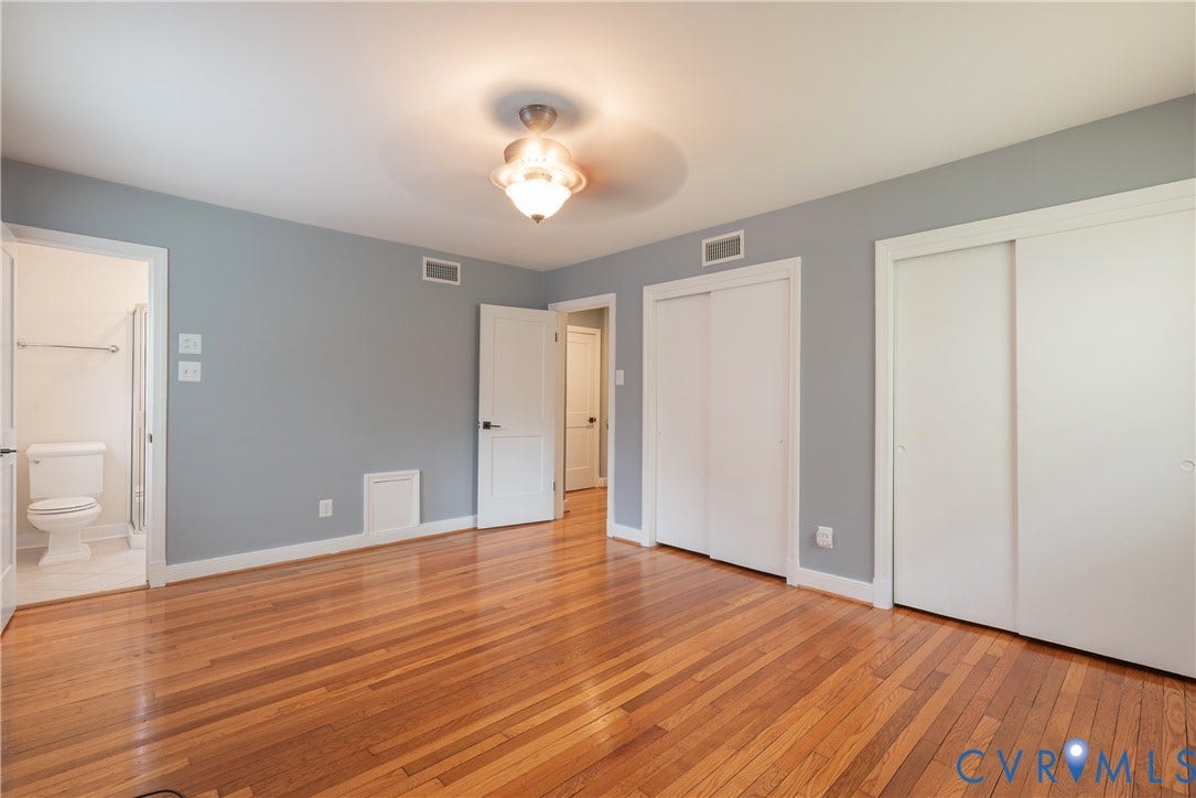 5709 Monument Avenue, Richmond, VA 23226 Primary Bedroom with Hardwood flooring, two sliding closet doors, ceiling light fixture, and a private bath