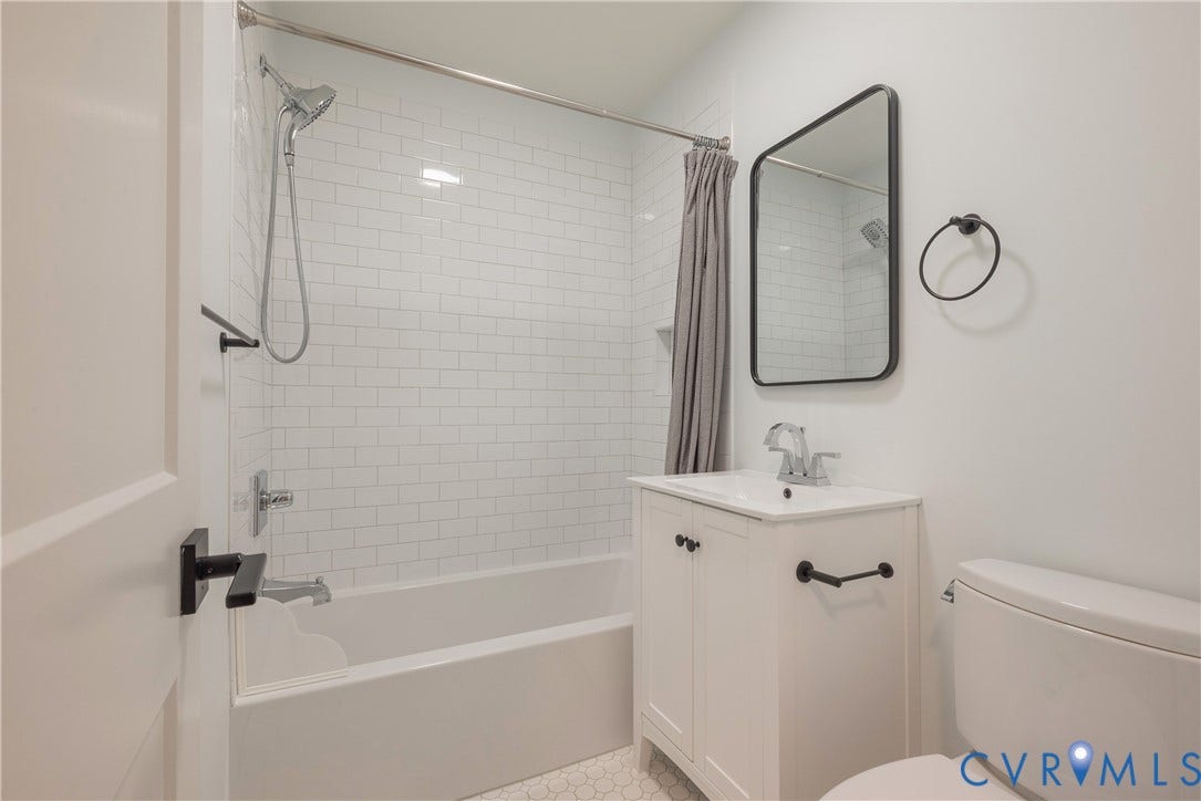 5709 Monument Avenue, Richmond, VA 23226 Hall Bath with white vanity, white subway tile shower surround with glass enclosure, tiles floor