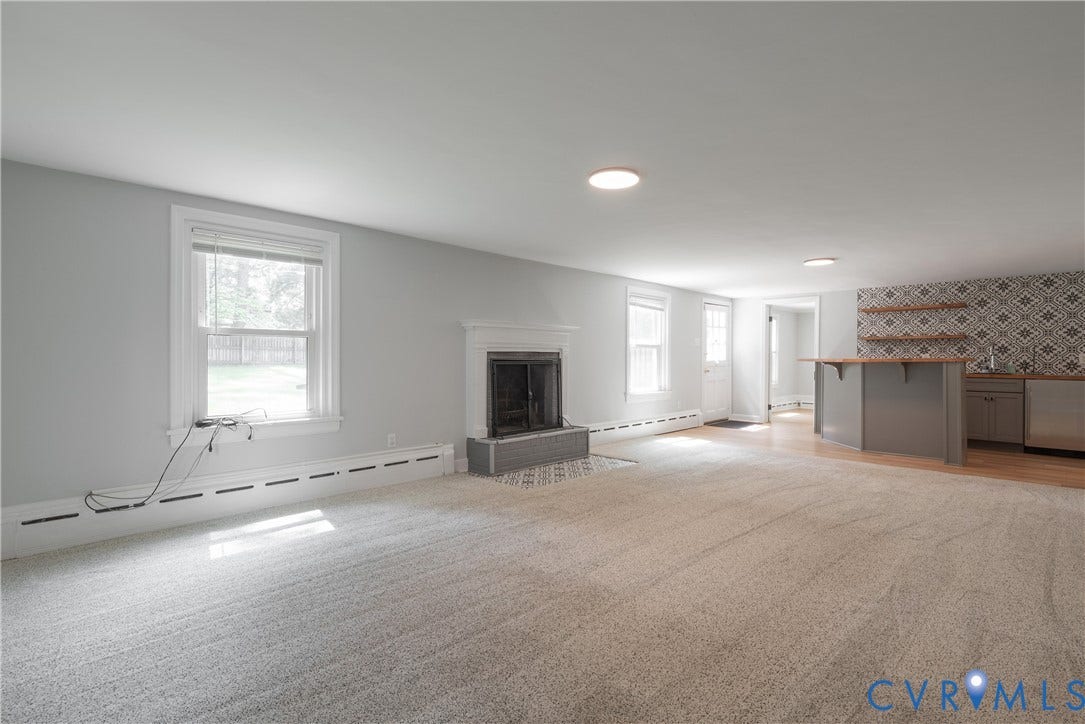5709 Monument Avenue, Richmond, VA 23226 Rec Room with Recessed lighting, light-toned carpeting, fireplace with a tile hearth, built-in bar with wood-finish countertop, patterned tile backsplash and access to the backyard