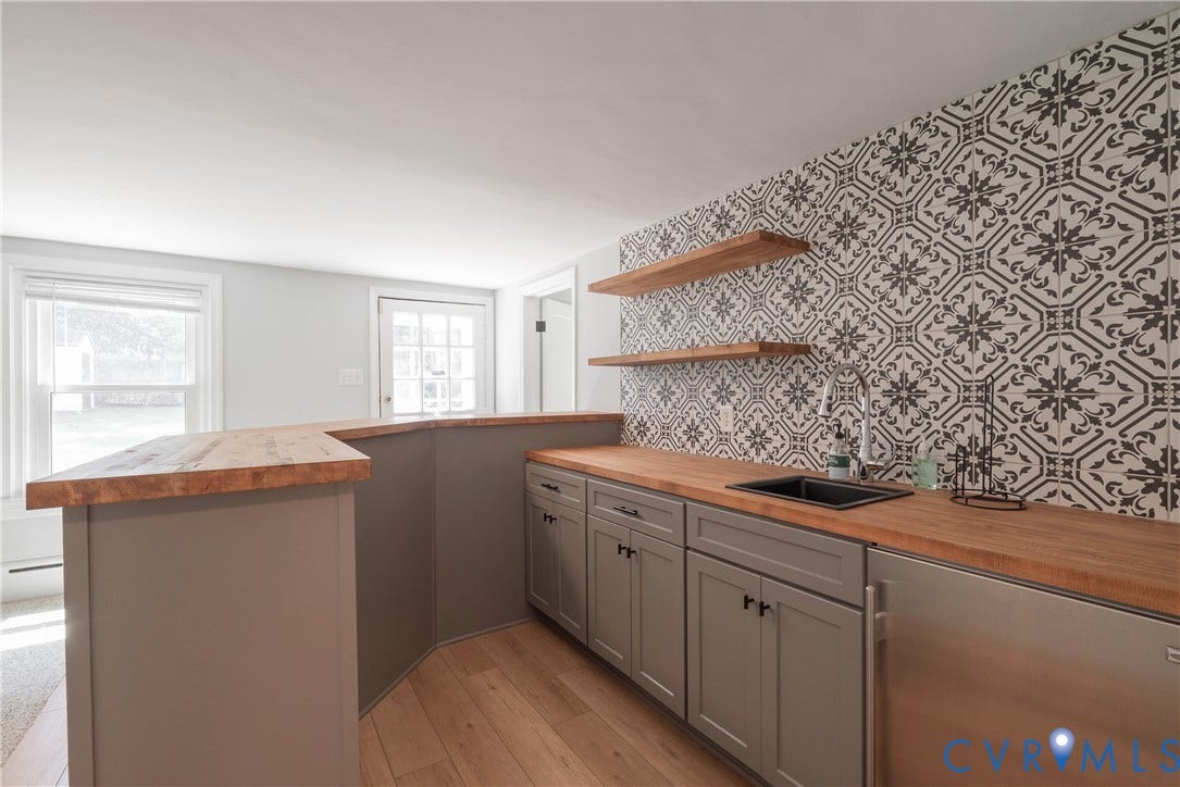5709 Monument Avenue, Richmond, VA 23226 Rec Room - Bar with custom shelving and a sink and decorative faucet