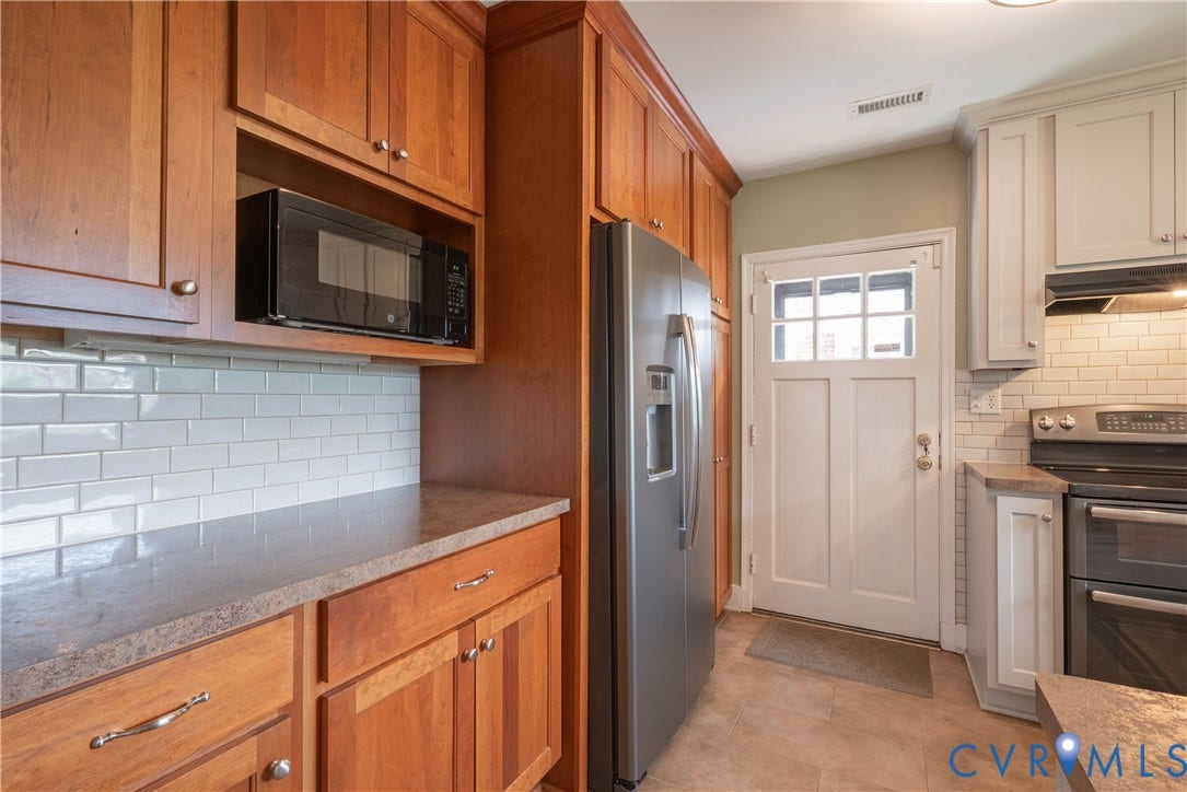 5709 Monument Avenue, Richmond, VA 23226 Custom Kitchen featuring wood cabinetry and easy access to the exterior