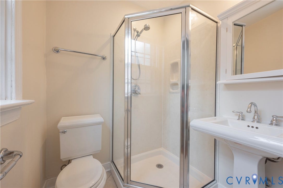 5709 Monument Avenue, Richmond, VA 23226 Primary Bathroom with Corner shower with glass enclosure, chrome fixtures, and a white pedestal sink