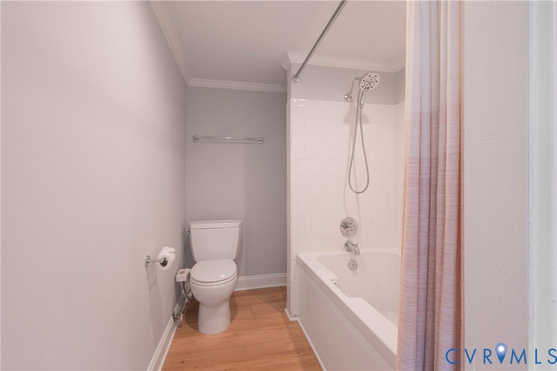 5709 Monument Avenue, Richmond, VA 23226 Lower Level Bath with a tub/shower combination with white subway tile surround, chrome fixtures, and wood-finish flooring