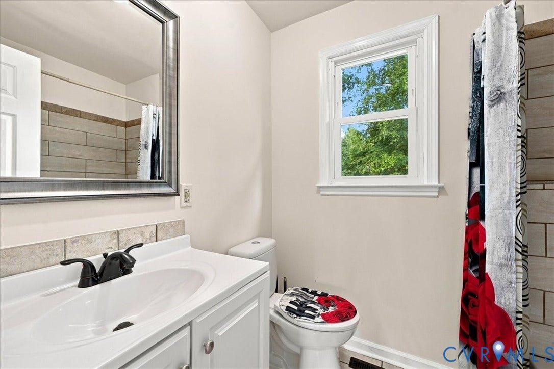 21103 Rabbit Run, Chesterfield, VA 23803 White vanity with an integrated sink and matte black faucet