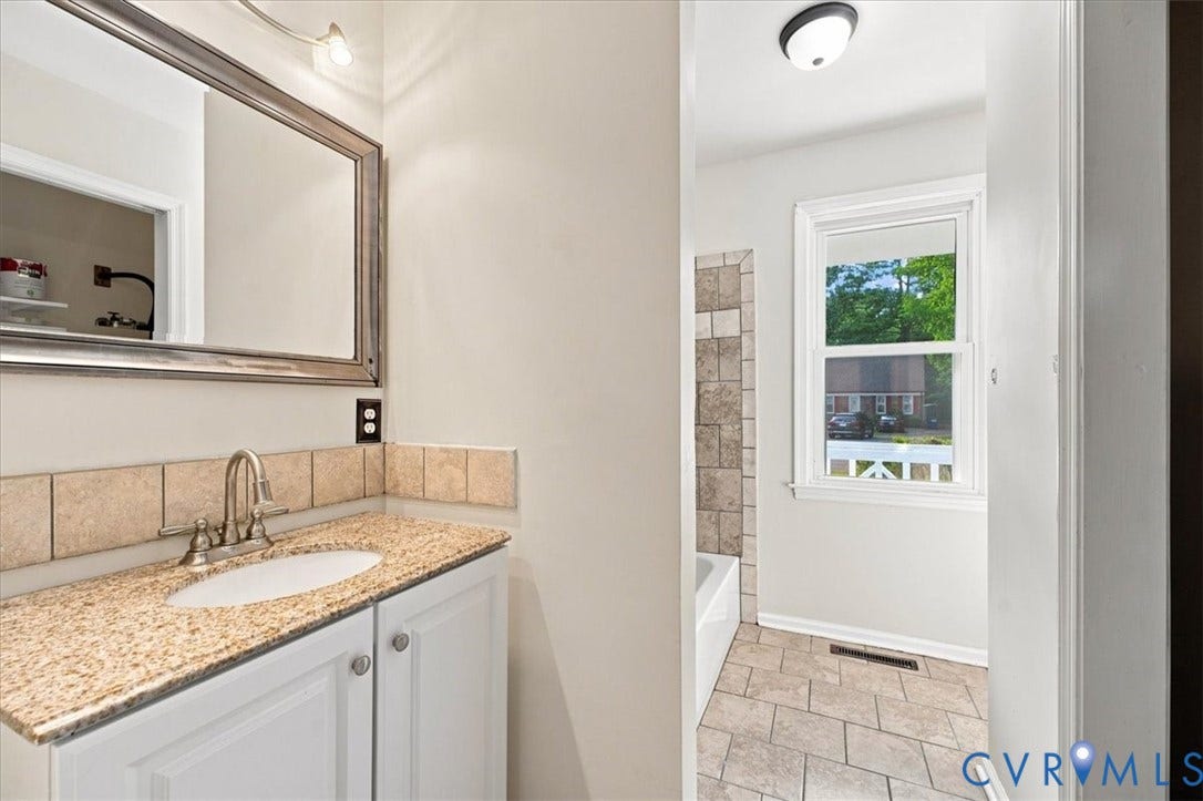 21103 Rabbit Run, Chesterfield, VA 23803 Bright bathroom featuring a granite-topped vanity with white cabinetry, polished nickel faucet, and framed mirror