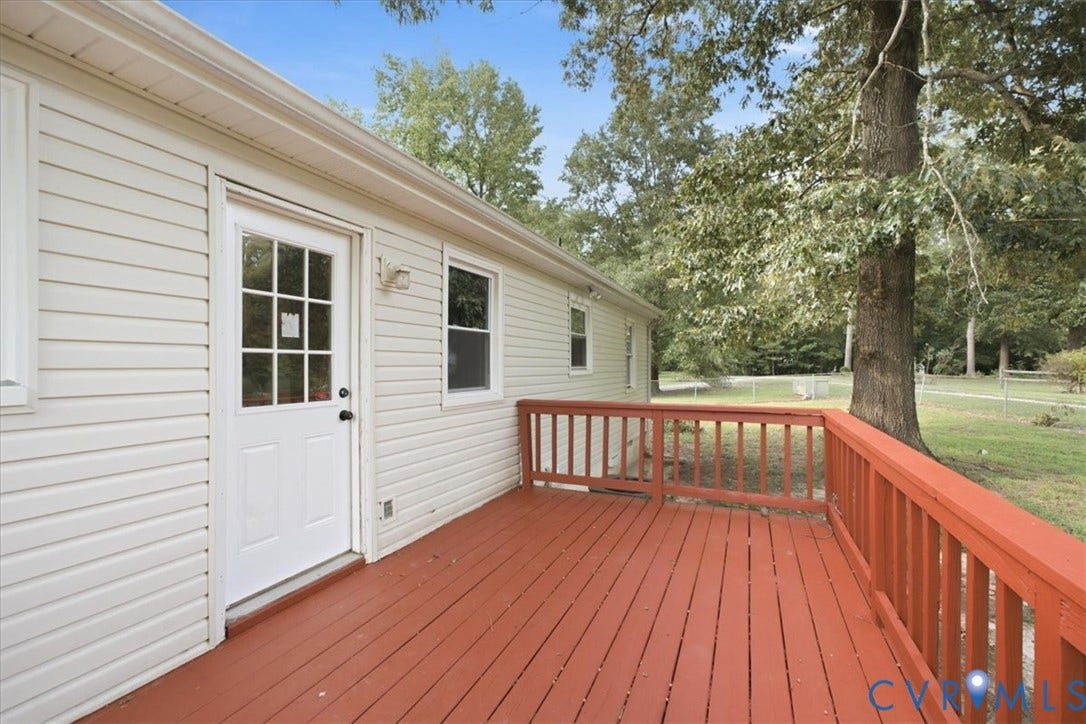21103 Rabbit Run, Chesterfield, VA 23803 Expansive wood deck with a red finish, white vinyl siding, and a white exterior door with glass lites