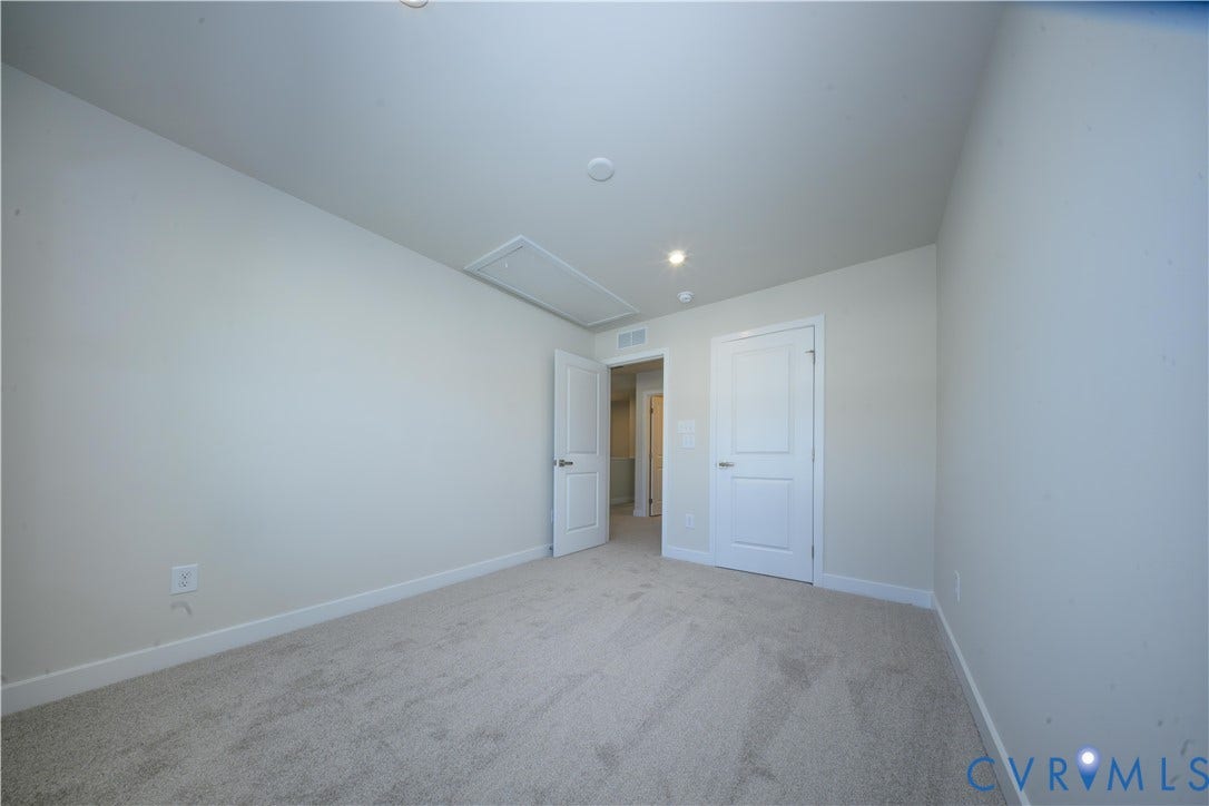 Neutral paint tones, carpet flooring, recessed lighting, and white paneled doors