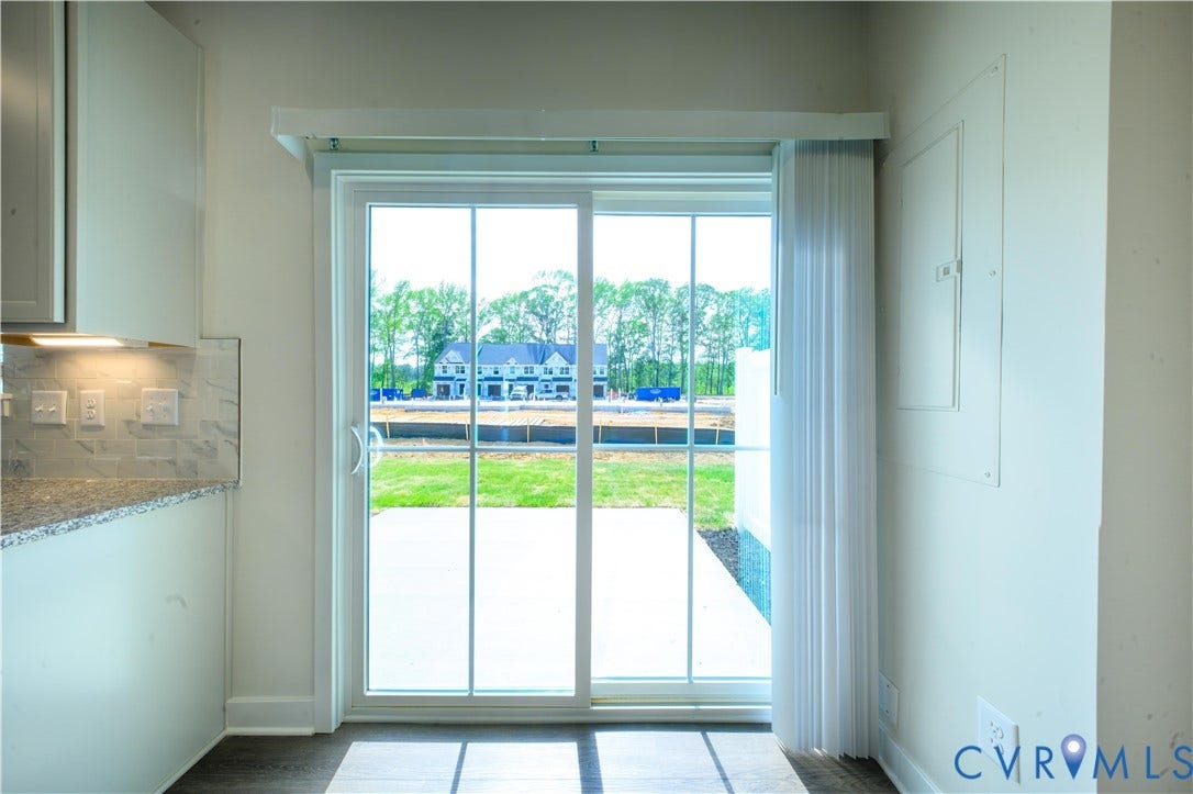 Sliding glass door leading to a concrete patio