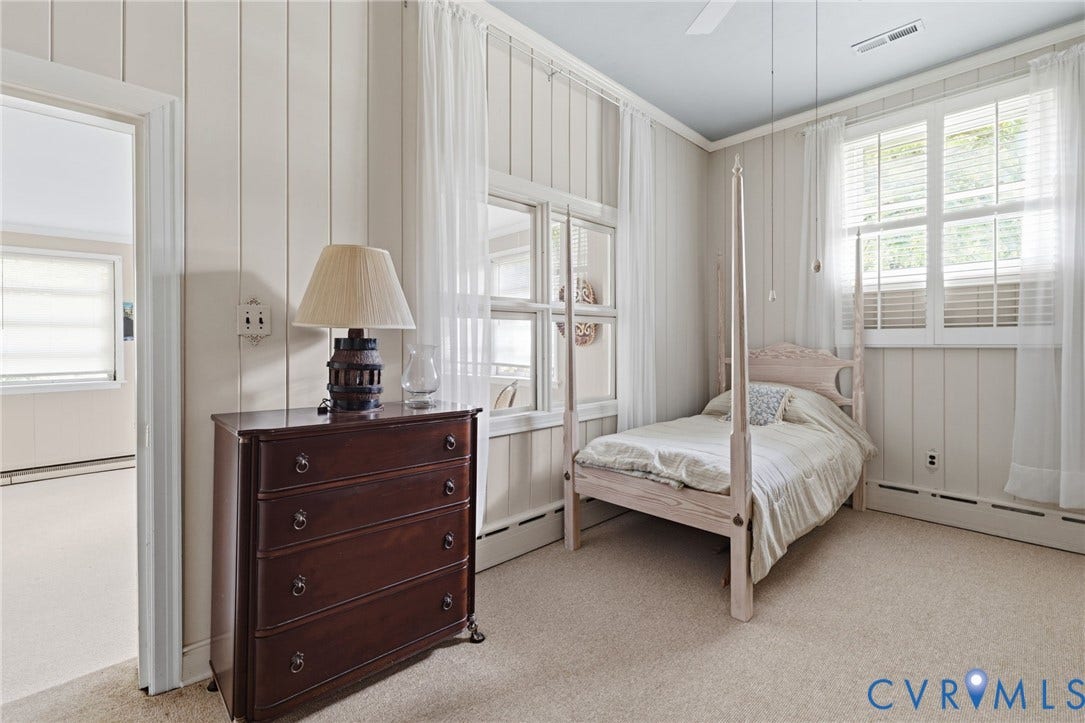 8208 Michael Road, Henrico, VA 23229 Soft neutral carpet flooring, vertical paneling walls, and multiple windows with white blinds