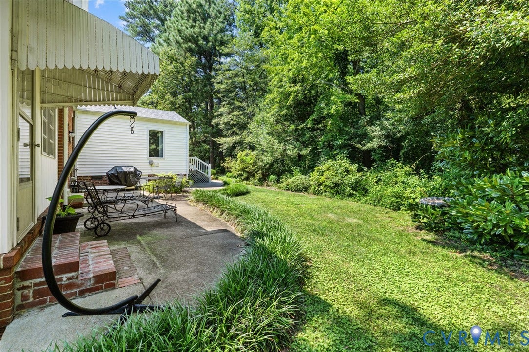 8208 Michael Road, Henrico, VA 23229 Expansive green lawn with mature trees, offering a secluded outdoor experience