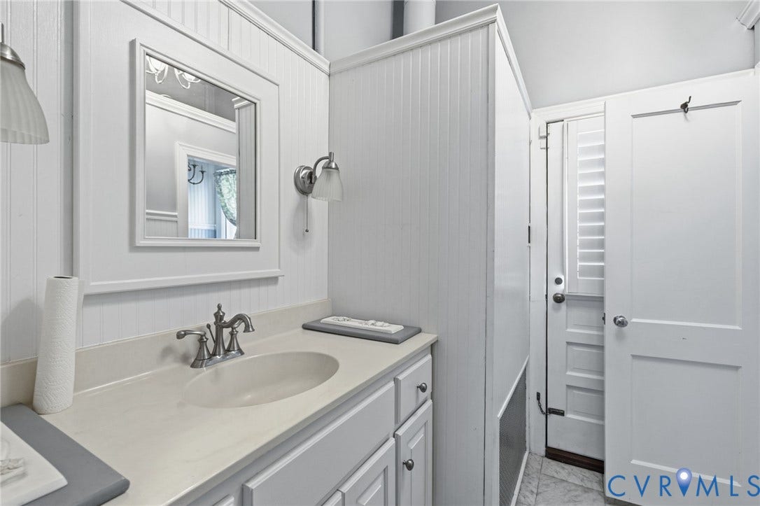 8208 Michael Road, Henrico, VA 23229 White vanity with a single basin sink and brushed nickel faucet