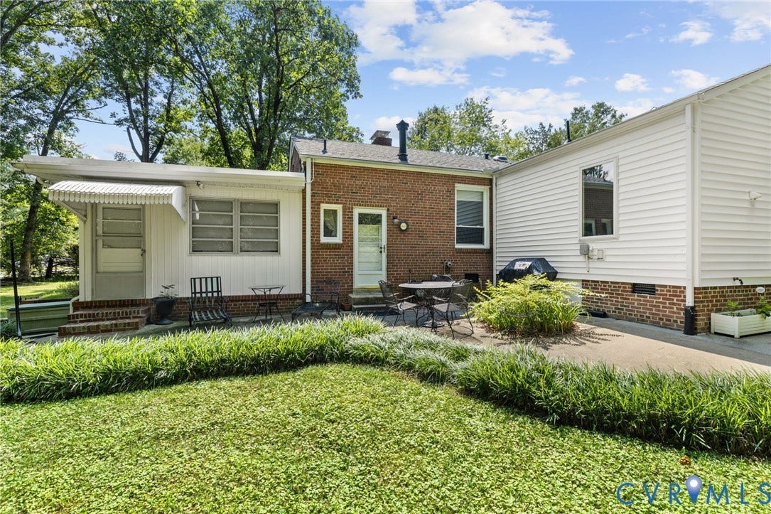 8208 Michael Road, Henrico, VA 23229 Brick and siding exterior with concrete patio, mature landscaping, and an awning over the entry