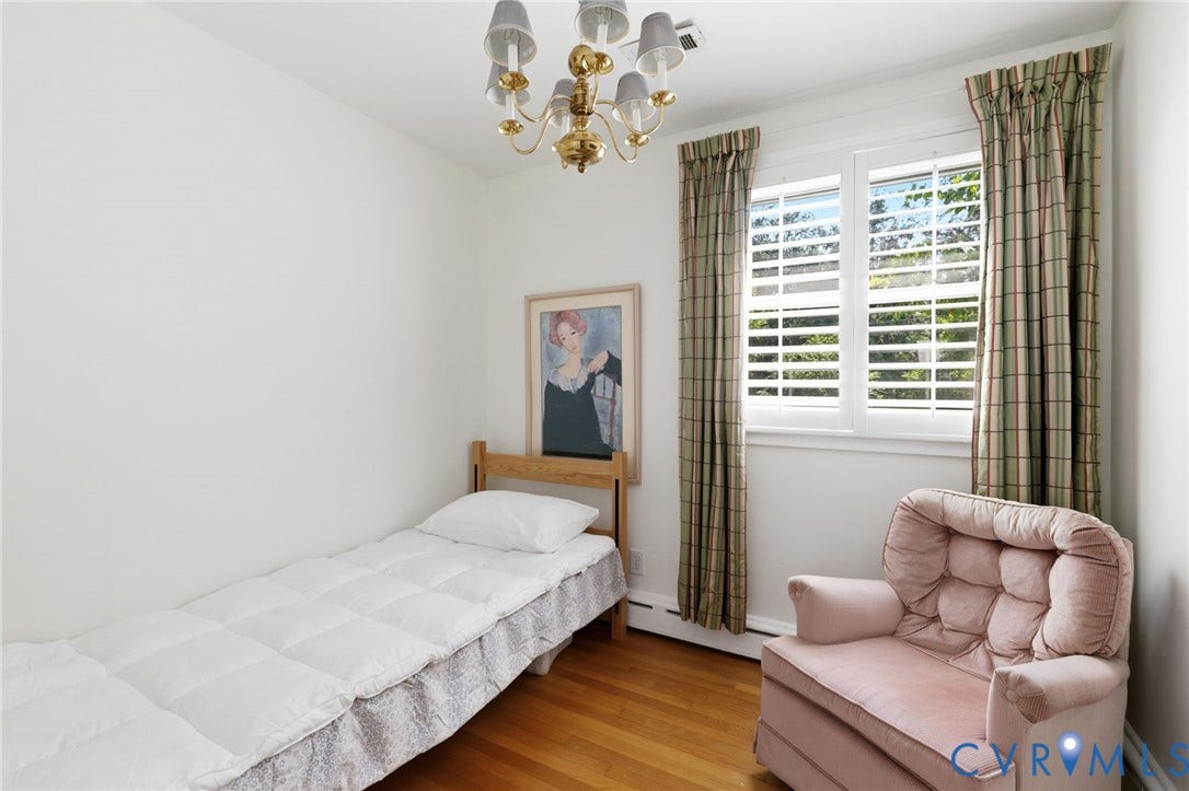 8208 Michael Road, Henrico, VA 23229 Hardwood flooring, white wall paint, window with plantation shutters, ceiling-mounted chandelier