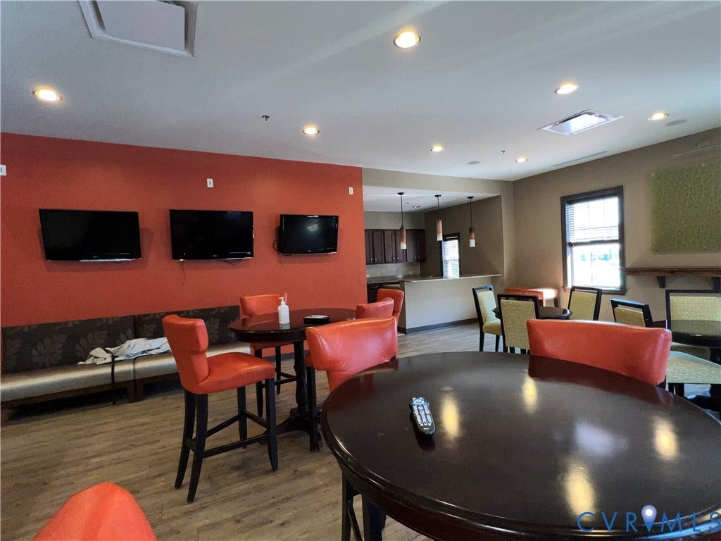 1901 Liesfeld Parkway, West Broad Village, Glen Allen, VA 23060 Recessed lighting throughout, wood-finish flooring, built-in bench seating, multiple wall-mounted screens, and a built-in bar with pendant lighting